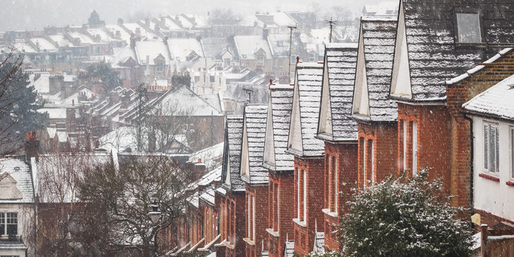 Identical English terraced houses covered by snow in Crouch End, London construction consultancy